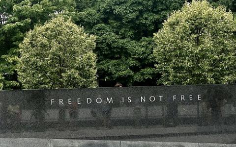 Freedom is not free printed on the granite wall.