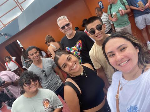 Interns smiling while standing with a group of people.