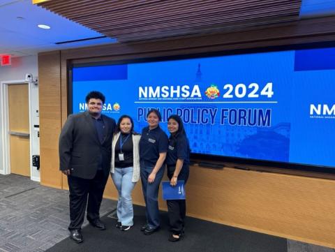 Berenice Verdugo standing with a group at a conference.